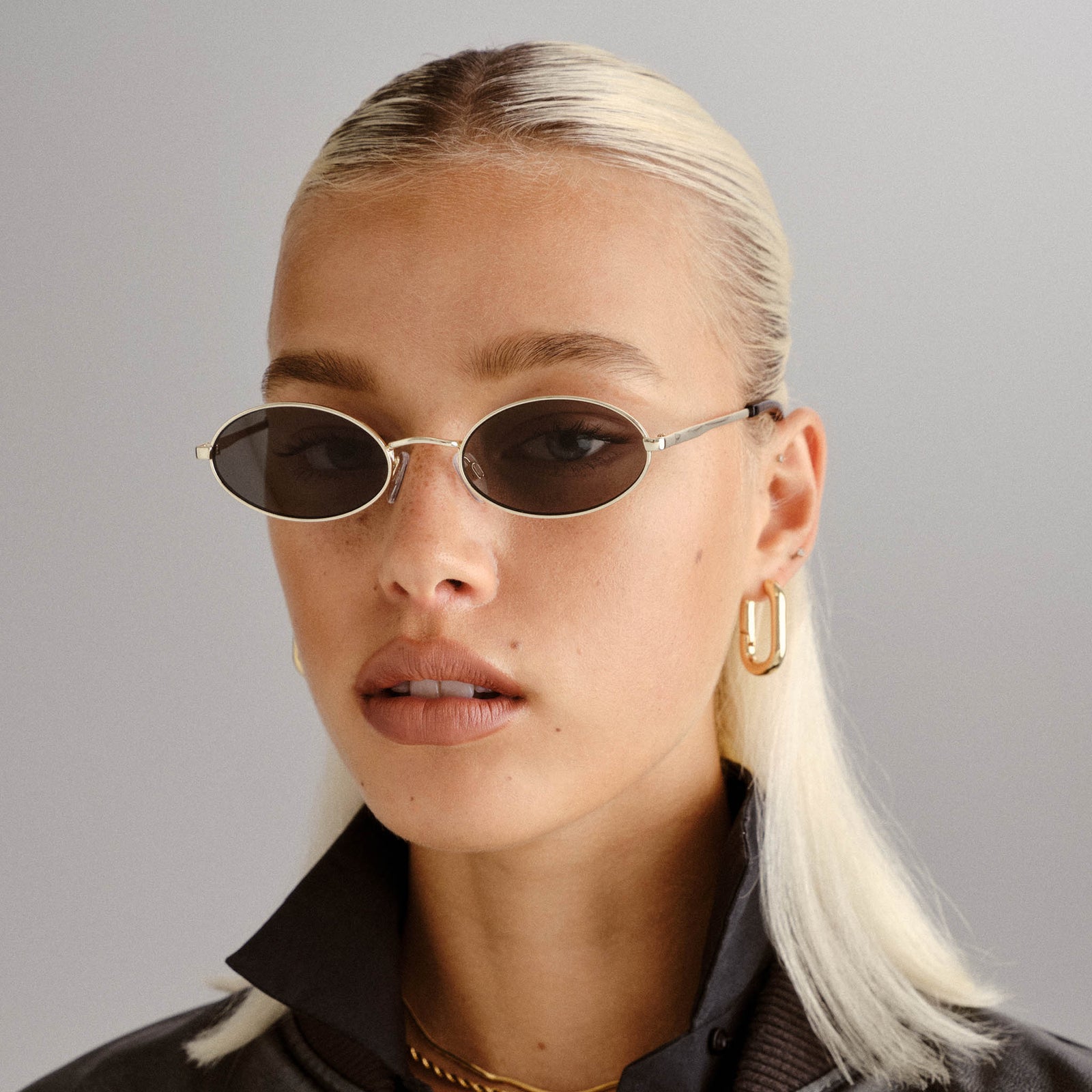 Love Train Bright Gold Female Oval Sunglasses | Le Specs
